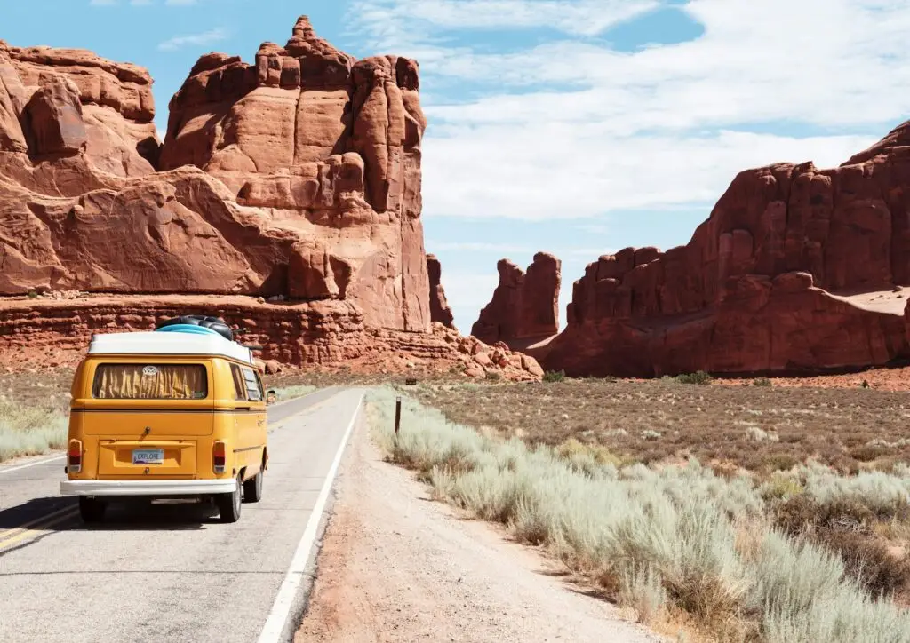 yellow Volkswagen van on rural road