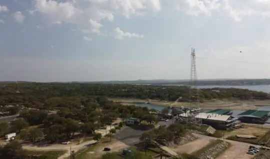 an aerial view of a lake and power lines