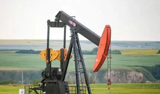 black and orange metal machine on green grass field during daytime