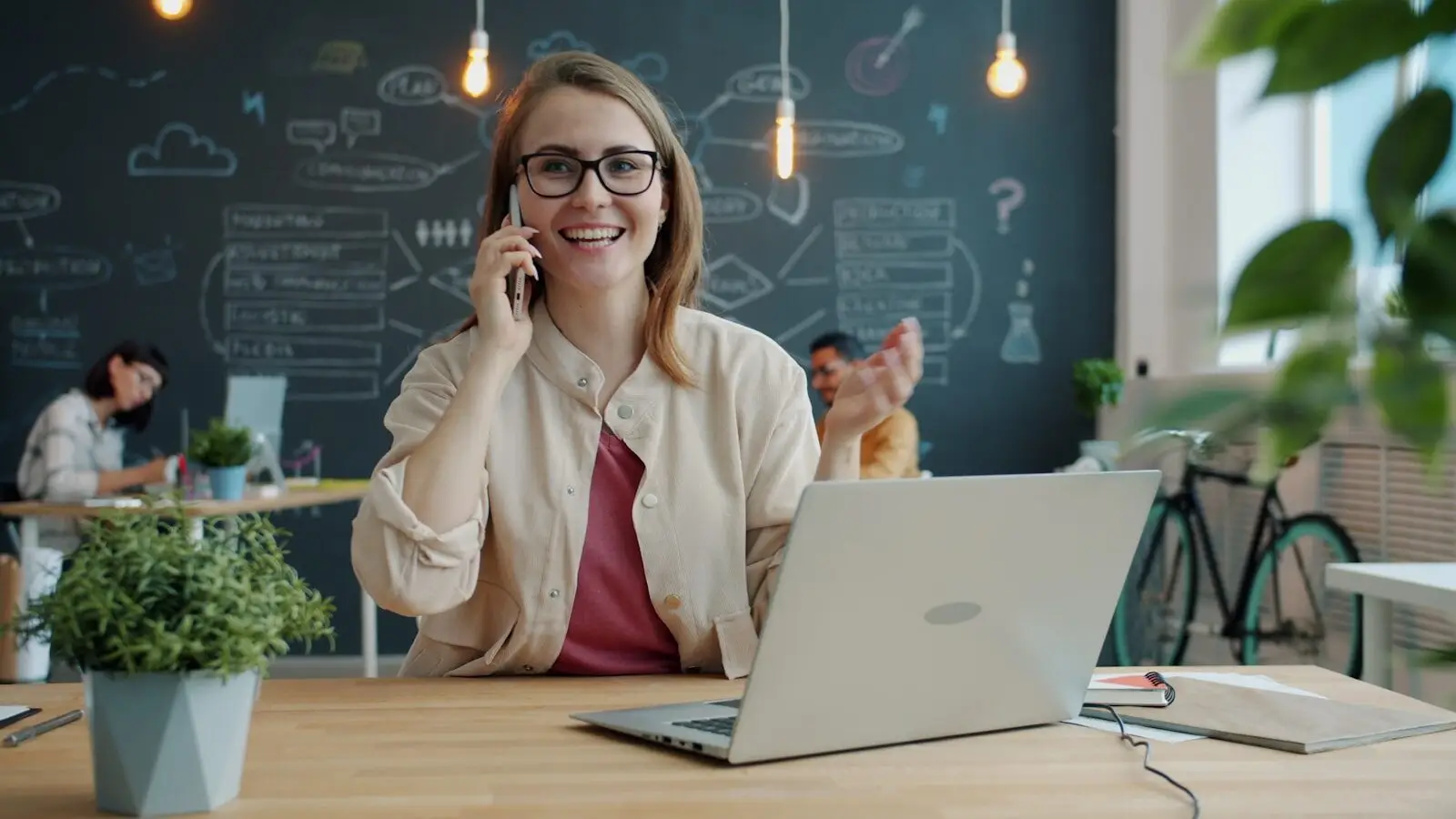 Photo by Vitaly Gariev - Daughtrey Law Firm Smiling woman talking on phone in modern office.