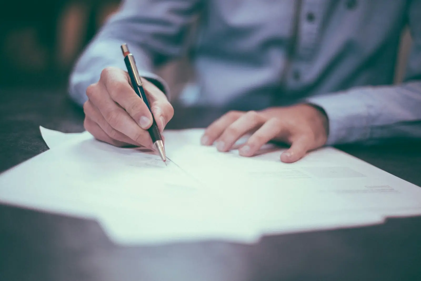 dlf-photo-1450101499163-c8848c66ca85 Signing a document, like an old Texas mineral deed whose usual one-eighth royalty language still governs today