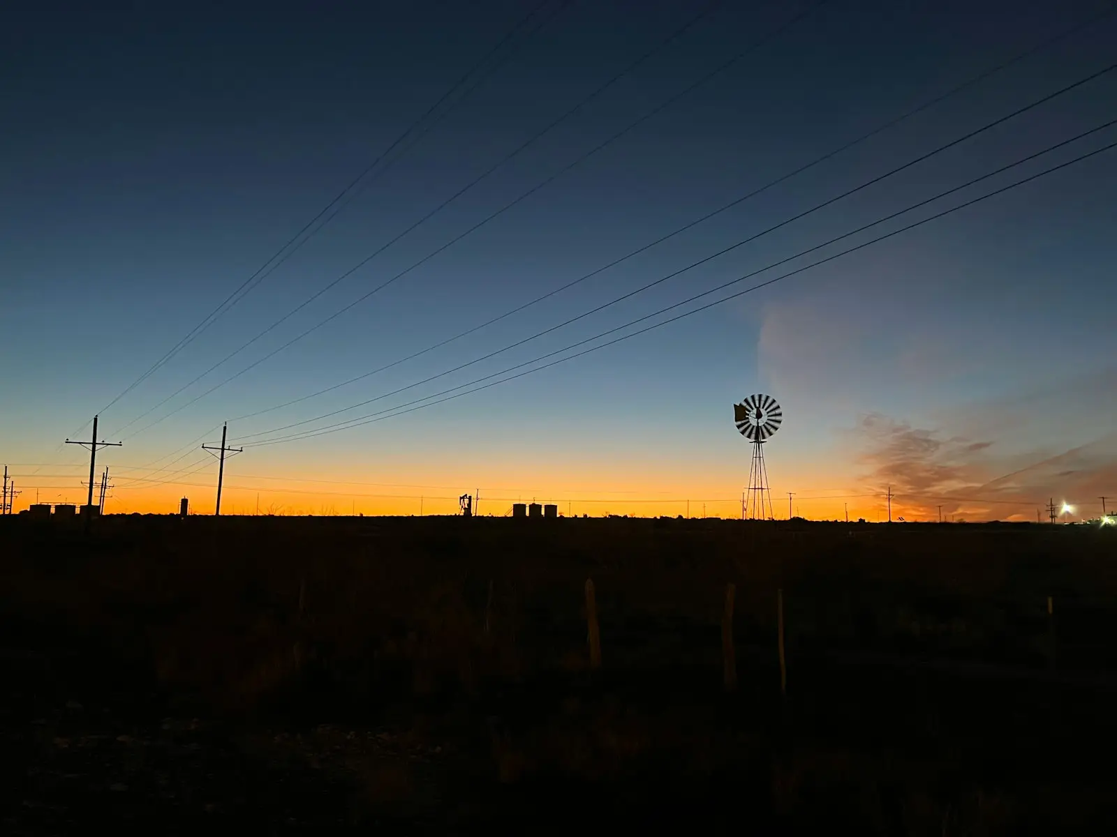 dlf-photo-1692155469916-67f9557b78ab West Texas oil field at sunrise, where a suspended mineral royalty check often traces to a title question